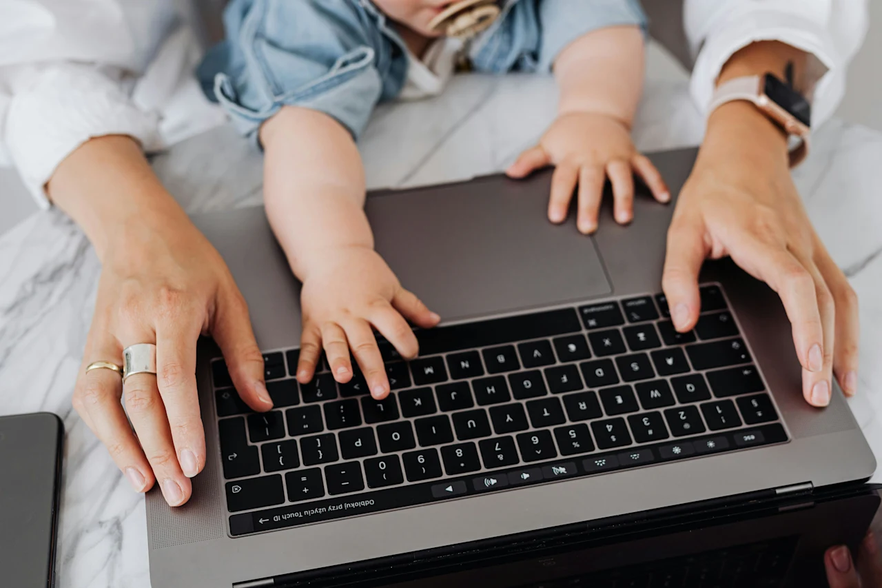 Parent and baby at laptop