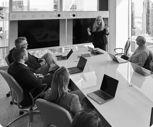 Team meeting with a presenter leading a discussion in a conference room