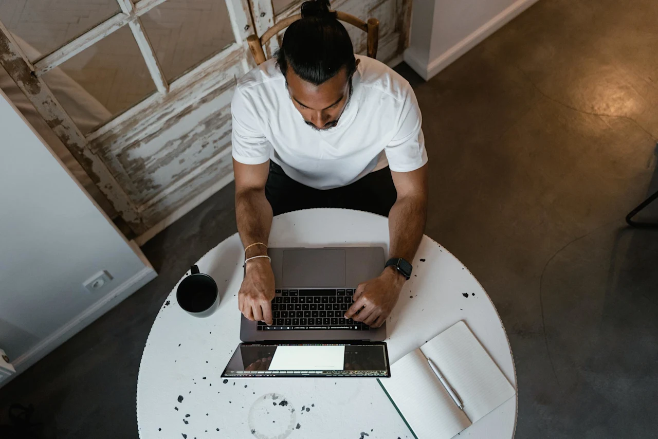 Man on computer researching financial security through estate and cryptocurrency planning as an employee benefit.