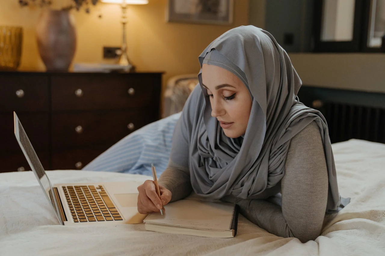 A woman writing in her notebook preparing her will.