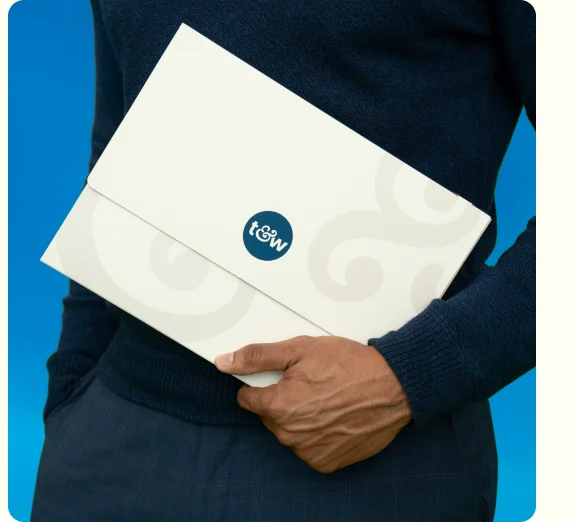 Person holding a Trust & Will estate and crypto plan folder
