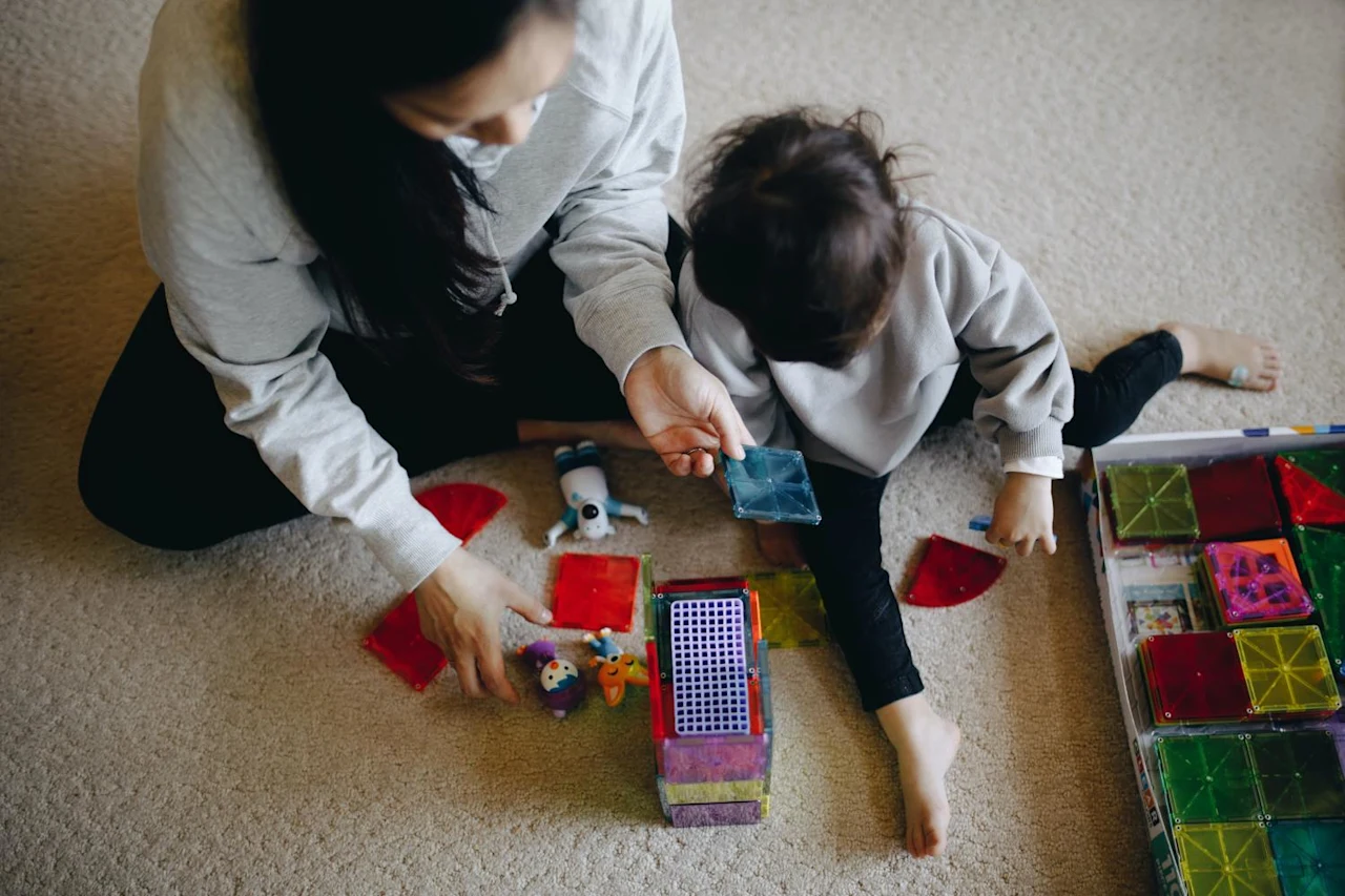 Woman playing with son after learning how filial responsibility laws can affect her.