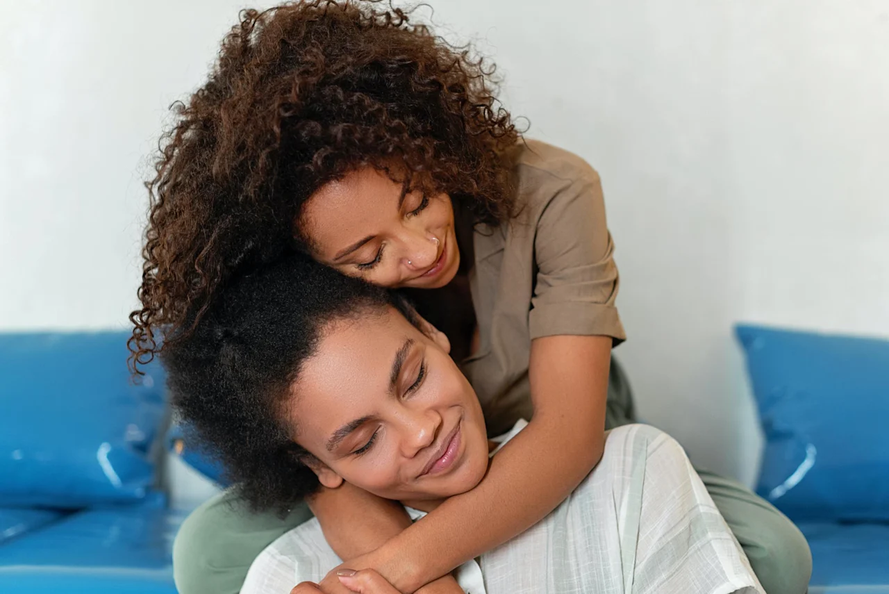 LGBTQIA couple hugging after completing their estate and cryptocurrency planning as en employer benefit.