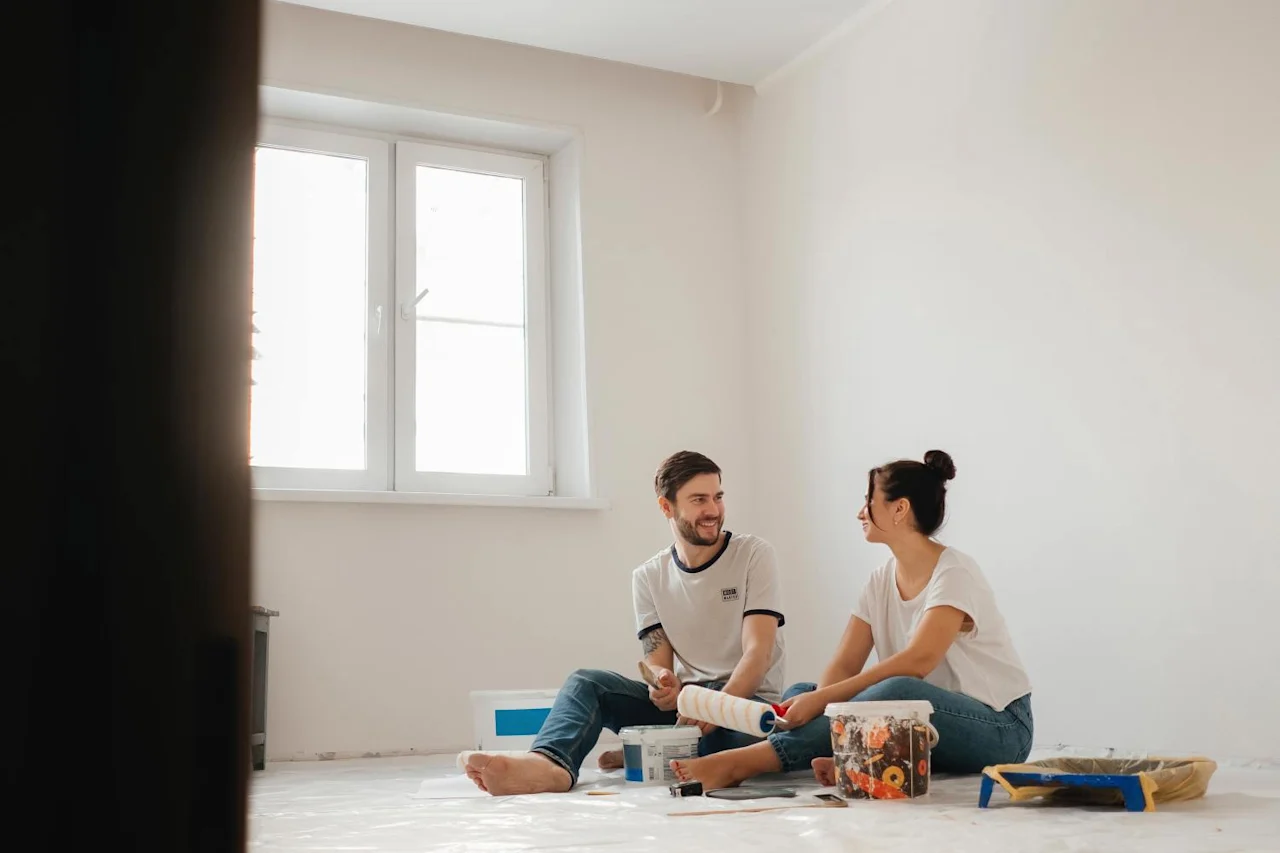 Couple sitting in new house after figuring out house deed.