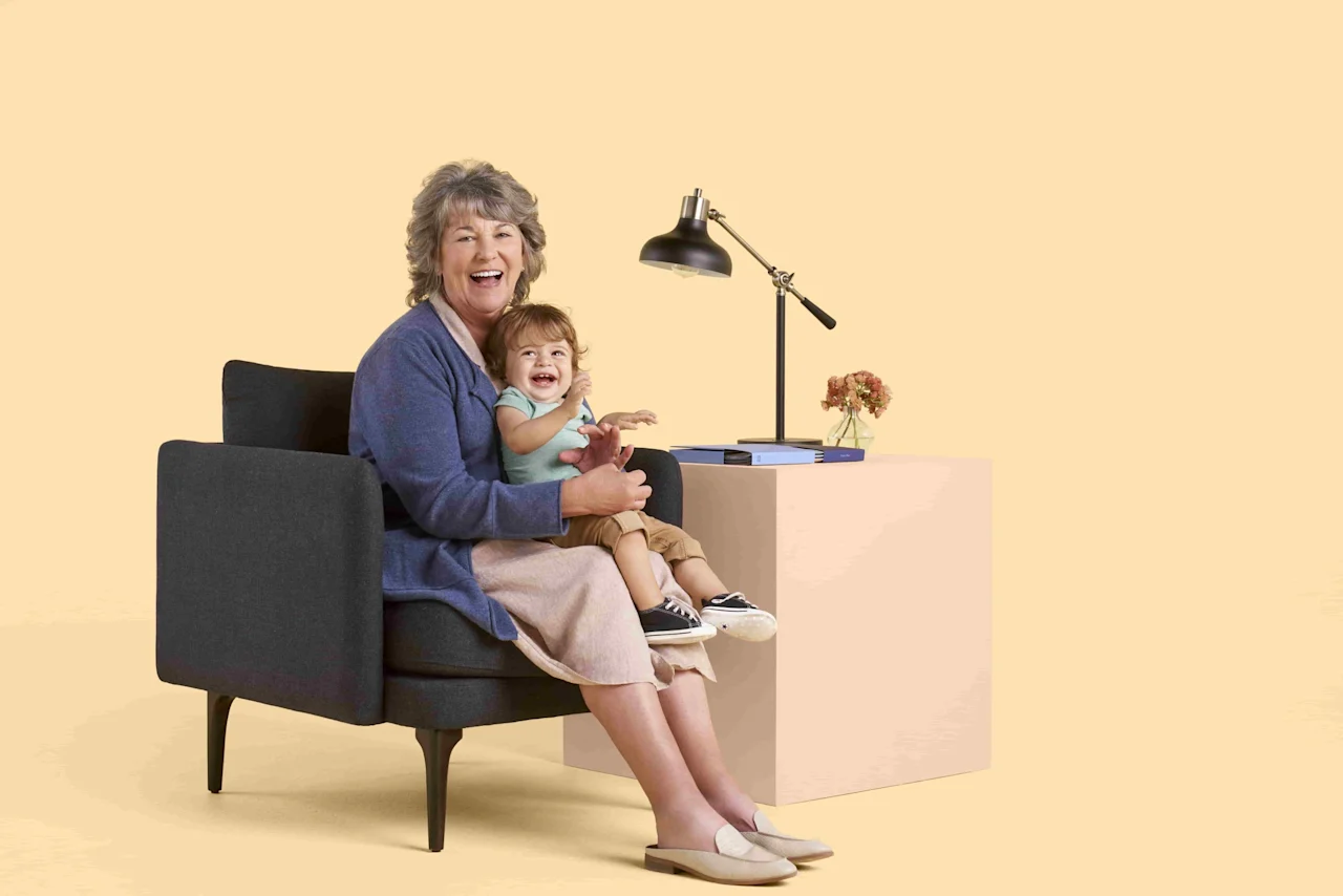grandmother holding grandchild laughing