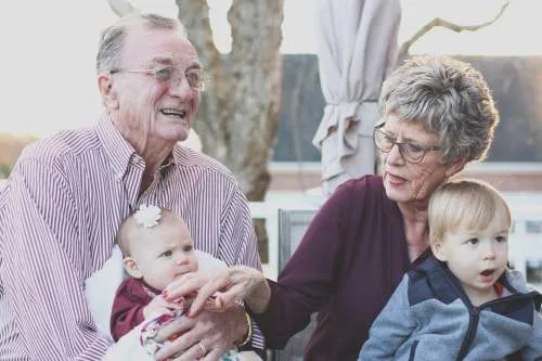 assumption of mortgage after death represented by grandparents are holding their grandchild. 