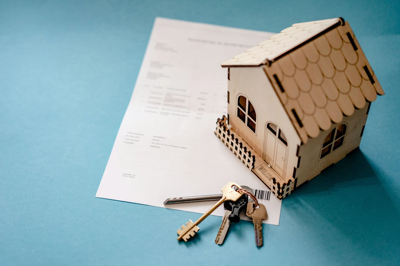 Wooden House, Keys and Contract on Table